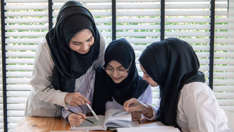 Two teachers working with a pupil.